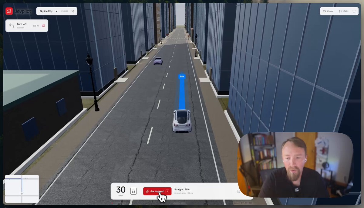Jevpilot driving a simulated car through a three-dimensional city.